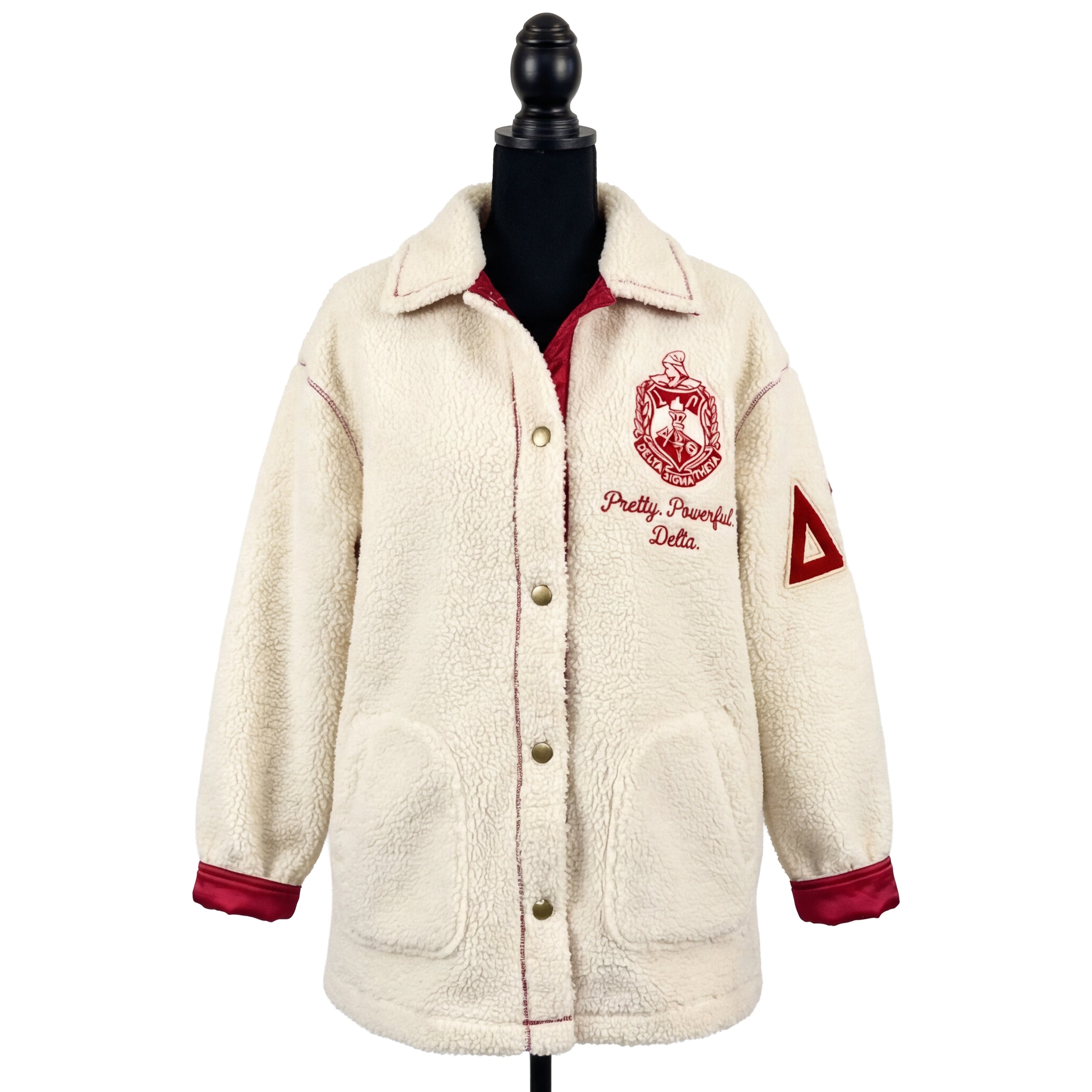 Cream-colored fleece jacket with red accents and embroidery on a mannequin against a white background