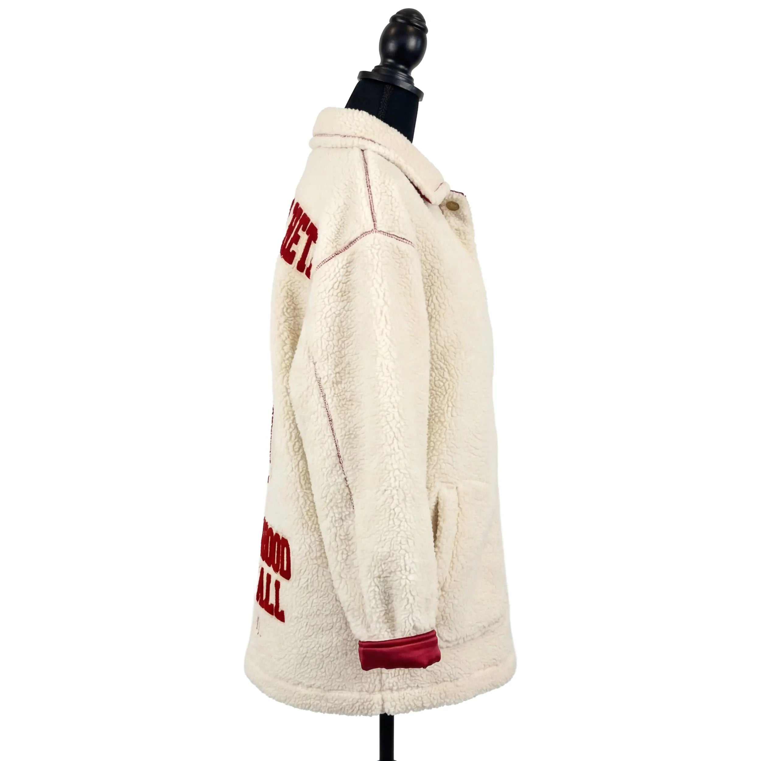White sherpa jacket with red text on a mannequin against a white background