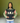 Young woman wearing AKA Alpha Kappa Alpha black pink green colorblock crewneck sorority sweatshirt with 1908 sleeve and ivy garland
