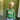 Woman wearing AKA Alpha Kappa Alpha green crewneck sorority sweatshirt with 1908 sleeve and rose embroidery styled with jeans
