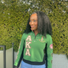 Woman wearing AKA Alpha Kappa Alpha green quarter-zip pullover with ivy pearl chest drape diagonal AKA letters and pink inner collar
