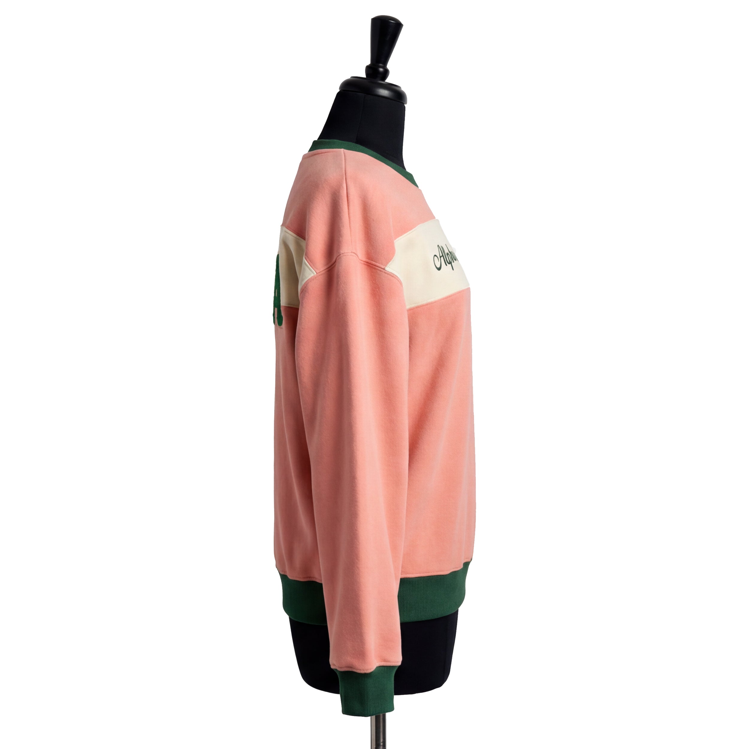 Mannequin wearing a pink and green sports jersey on a white background
