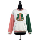 Sweatshirt with a crest design on a mannequin against a white background