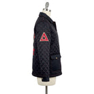 Black quilted jacket with red triangle design on a mannequin against a white background