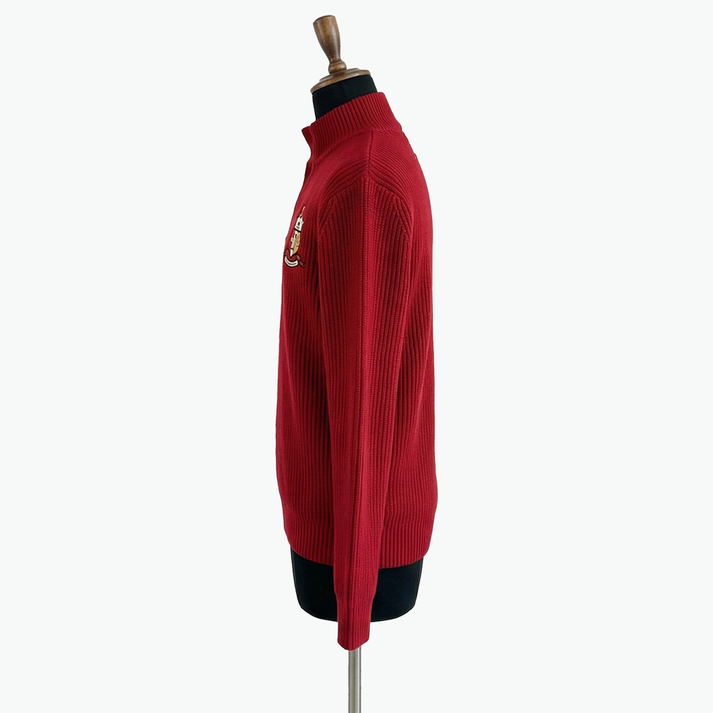 Red sweater on a mannequin against a white background